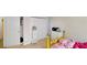 Bright bedroom with a closet, dresser, and a twin bed with yellow frame at 59 Abbotsford Dr, Villa Rica, GA 30180