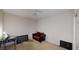 Spacious bedroom with a cozy black futon and flat screen TV at 59 Abbotsford Dr, Villa Rica, GA 30180