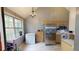 Bright kitchen boasts stainless steel appliances, tiled floor, and natural light from large window at 59 Abbotsford Dr, Villa Rica, GA 30180