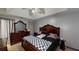 Spacious main bedroom featuring a tray ceiling, decorative mirror, and dark wood furniture at 59 Abbotsford Dr, Villa Rica, GA 30180