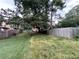 Spacious fenced backyard with mature trees, offering privacy and shade at 1038 Westfield Se Trce, Smyrna, GA 30082