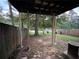 Backyard featuring a wooden fence, mature trees, and a covered porch at 1038 Westfield Se Trce, Smyrna, GA 30082