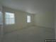 A bright bedroom with two windows, carpet, and neutral walls at 1038 Westfield Se Trce, Smyrna, GA 30082