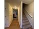 Inviting hallway featuring hardwood floors, stairs, and views into the adjacent living area at 1038 Westfield Se Trce, Smyrna, GA 30082