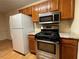 Updated kitchen featuring stainless steel appliances and light countertops, and wood cabinets at 1038 Westfield Se Trce, Smyrna, GA 30082