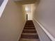Interior staircase with carpeted steps and white handrail, leading to the upper level of the home at 1038 Westfield Se Trce, Smyrna, GA 30082