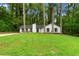 Charming single-story home with a well-maintained lawn and mature trees providing shade and curb appeal at 1490 Diplomat Dr, Riverdale, GA 30296