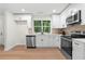 Bright kitchen featuring stainless steel appliances, ample cabinet space, and a large window at 1490 Diplomat Dr, Riverdale, GA 30296