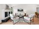 Bright living room with fireplace, contemporary furniture, and a large picture window, offering a cozy space at 1490 Diplomat Dr, Riverdale, GA 30296