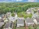 Wide aerial shot showcasing a residential area surrounded by a dense forest at 2376 Roberts View Trail, Buford, GA 30519
