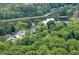Houses surrounded by lush trees with a tranquil lake in the background at 2376 Roberts View Trail, Buford, GA 30519