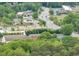 An aerial view of a neighborhood with lush greenery and commercial establishments at 2376 Roberts View Trail, Buford, GA 30519