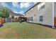 The backyard features a well-maintained lawn, a gazebo with furniture, a storage shed, and a wooden fence at 2376 Roberts View Trail, Buford, GA 30519
