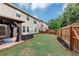 The backyard features a gazebo, a well-maintained lawn, and a wooden fence for privacy and security at 2376 Roberts View Trail, Buford, GA 30519