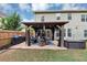 The backyard patio with a gazebo, grill, hot tub, outdoor seating, and a green lawn, great for relaxing and socializing at 2376 Roberts View Trail, Buford, GA 30519