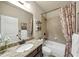 Well-lit bathroom with granite countertop, decorative shower curtain, and tiled shower at 2376 Roberts View Trail, Buford, GA 30519