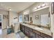 Bathroom featuring double sink vanity, soaking tub, and natural light at 2376 Roberts View Trail, Buford, GA 30519