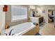 Elegant bathroom featuring soaking tub and granite countertops at 2376 Roberts View Trail, Buford, GA 30519