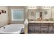 Bright bathroom featuring separate tub, granite counters, and lots of natural light at 2376 Roberts View Trail, Buford, GA 30519