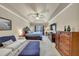 Spacious bedroom featuring tray ceiling, ceiling fan, and ample furniture space at 2376 Roberts View Trail, Buford, GA 30519