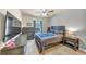 Cozy bedroom with carpeted floors, complemented by wood furnishings and a ceiling fan at 2376 Roberts View Trail, Buford, GA 30519
