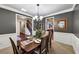 Charming dining room with classic wainscoting, chandelier, and easy access to other living spaces at 2376 Roberts View Trail, Buford, GA 30519