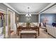 Formal dining room with elegant decor, chandelier lighting, and a seamless flow into the living area at 2376 Roberts View Trail, Buford, GA 30519