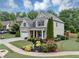 Attractive home featuring manicured landscaping, a lush lawn, and a welcoming covered entryway at 2376 Roberts View Trail, Buford, GA 30519