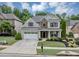 Charming brick home with a well-manicured lawn, a two-car garage, and a cozy front porch at 2376 Roberts View Trail, Buford, GA 30519