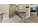 Spacious second floor hallway with carpet and wooden banister leading to the entertainment space at 2376 Roberts View Trail, Buford, GA 30519