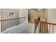 Hallway with carpet, natural lighting, and a beautiful wooden banister that adds warmth and character at 2376 Roberts View Trail, Buford, GA 30519
