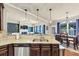 Open-concept kitchen with granite countertops, stainless steel dishwasher, and breakfast bar overlooking the living space at 2376 Roberts View Trail, Buford, GA 30519