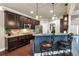 Modern kitchen with granite countertops, stainless steel appliances, breakfast bar seating, and dark cabinets at 2376 Roberts View Trail, Buford, GA 30519