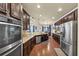 Gourmet kitchen featuring stainless steel appliances, granite countertops and wooden cabinets, and a breakfast area at 2376 Roberts View Trail, Buford, GA 30519