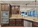 Bright, spacious kitchen with granite countertops, dark wood cabinetry, stainless steel appliances, and tiled backsplash at 2376 Roberts View Trail, Buford, GA 30519