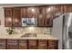 Gourmet kitchen with granite countertops, a cooktop, and stainless steel appliances including a stainless refrigerator at 2376 Roberts View Trail, Buford, GA 30519