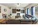Bright living room features a fireplace, built-ins, a ceiling fan, and comfortable leather couches at 2376 Roberts View Trail, Buford, GA 30519
