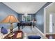 Stylish living room with a grand piano, inviting armchairs, and ample natural light from the window at 2376 Roberts View Trail, Buford, GA 30519