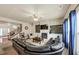 Open-concept living room boasts a fireplace, built-in shelves, staircase, and modern furnishings at 2376 Roberts View Trail, Buford, GA 30519