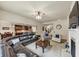 Large living room with fireplace, connecting to kitchen and dining area with modern decor at 2376 Roberts View Trail, Buford, GA 30519