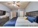 Relaxing bedroom featuring a large bed, modern decor, and a well-lit dresser area at 2376 Roberts View Trail, Buford, GA 30519