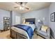 Comfortable bedroom with a ceiling fan, neutral colors, and a cozy seating area at 2376 Roberts View Trail, Buford, GA 30519