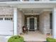 Inviting front porch and entry with stone accents, a seating area, and classic design details at 2376 Roberts View Trail, Buford, GA 30519
