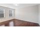 Bedroom features hardwood floors and windows that provide ample natural light at 5195 Belmore Manor Ct, Suwanee, GA 30024