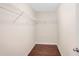 Walk-in closet features built-in white wire shelving and dark hardwood floors at 5195 Belmore Manor Ct, Suwanee, GA 30024
