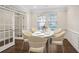 Dining room with modern chairs and table, hardwood floors, and beautiful bright light at 5195 Belmore Manor Ct, Suwanee, GA 30024