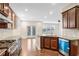 Modern kitchen with granite countertops, stainless steel appliances, and dark wood cabinets at 5195 Belmore Manor Ct, Suwanee, GA 30024