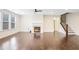 Spacious living room with hardwood floors, a cozy fireplace, and staircase access at 5195 Belmore Manor Ct, Suwanee, GA 30024