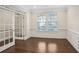 Bright living room with hardwood floors, white wainscoting and trim, and natural light at 5195 Belmore Manor Ct, Suwanee, GA 30024
