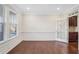 Bright living room with hardwood floors, white wainscoting and trim, and natural light at 5195 Belmore Manor Ct, Suwanee, GA 30024